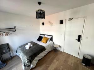 リエヴァンにあるVue sur les Toits - 2p Centre-villeのベッドルーム1室(黄色い枕のベッド1台付)