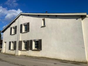 a white building with windows on the side of it at Le Miribel in Miribel