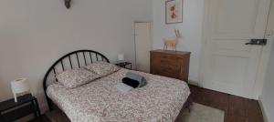 a bedroom with a bed with a laptop on it at Studio Les Armuriers, 2e ét sans asc in Condom