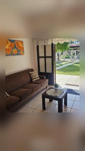a living room with a couch and a coffee table at Casa Andar Térreo - Balneário Nordeste - Imbé - RS in Imbé