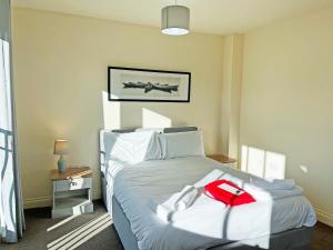 a bedroom with a bed with a plane on the wall at Solara Breeze in Reighton +6 photos