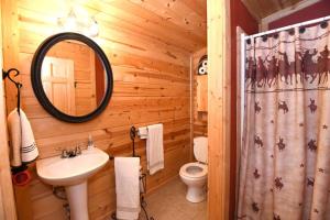 a bathroom with a sink and a toilet and a mirror at Kay's River Escape in Utopia +3 photos