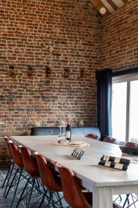 a table with a bottle of wine on top of it at Vakantiehoeve Amadee in Zonnebeke