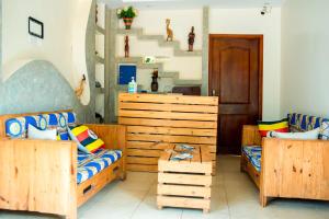 um quarto com 2 camas individuais e uma cabeceira em madeira em Go Culture Africa em Entebbe