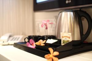 a tray with a coffee pot in a microwave at Venus Boutique Hotel in Melaka