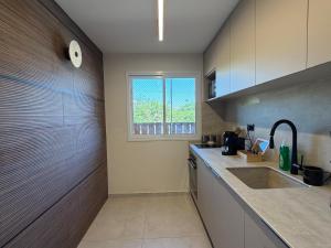 a kitchen with a sink and a window at onyx in Eilat +16 photos