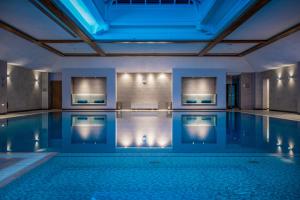 a large swimming pool with a blue ceiling at Cottons Hotel and Spa in Knutsford