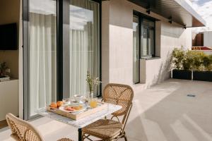 a table with a tray of fruit on a balcony at Hotel Pax Atocha in Madrid