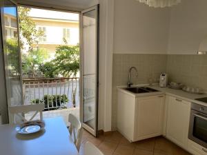 a kitchen with a table and a sink and a window at Il Giardino Segreto in Capo dʼOrlando