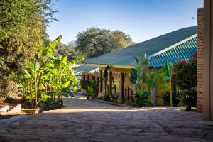 a cobblestone street in front of a building at Simanya River Lodge in Kanyekama