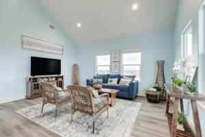 a living room with a couch and a tv at Prime Beachfront Large Deck Family Fun in Port Bolivar