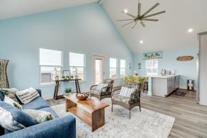 a living room with a blue couch and chairs at Prime Beachfront Large Deck Family Fun in Port Bolivar