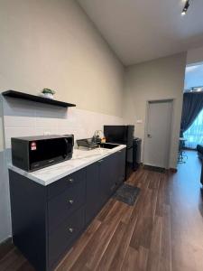 a kitchen with a counter with a microwave on it at Mahkota Valley Suite, Lemmie Stay in Kuantan +18 photos