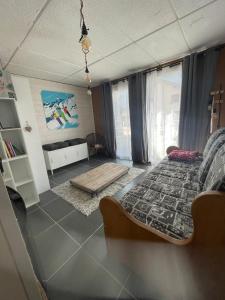 a bedroom with a bed and a living room at la skibelle Orelle-ValThorens-Spa -bain nordique -salle de sport in Orelle