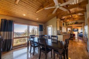 a dining room with a table and chairs and a large window at A Nest With a View in Blowing Rock