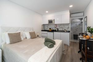 a bedroom with a large bed and a kitchen at OurMadeira - TerraceSea Caldeirão Verde in Ribeira Brava