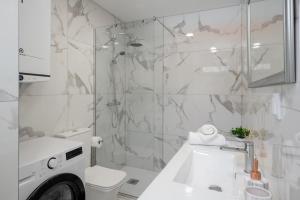 a bathroom with a sink and a toilet and a shower at OurMadeira - TerraceSea Caldeirão Verde in Ribeira Brava