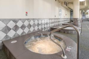 a bath room with a bath tub filled with water at The Oasis 2209 formerly Phoenix West II 2209 condo in Romar Beach