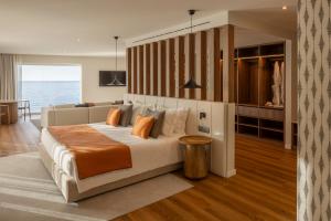 a bedroom with a large bed and a couch at Arribas Sintra Hotel in Sintra