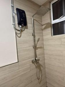 a shower stall in a bathroom with a shower at Mahkota Valley Suite, Lemmie Stay in Kuantan