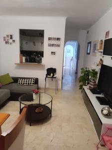a living room with a couch and a table at Apartamento Residencial mojacar in Mojácar