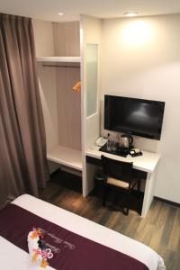 a room with a desk and a tv and a bed at Venus Boutique Hotel in Malacca +53 photos