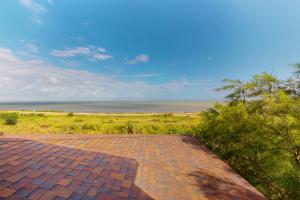 a brick walkway with a view of the ocean at Casa Sol Y Mar in Port Isabel