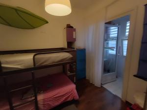 a bedroom with a bunk bed and an umbrella on the wall at Apartamento Residencial mojacar in Mojácar