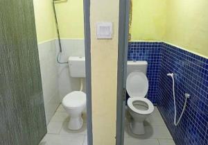 a bathroom with two toilets and blue tile walls at Mersing Barokahhill Beach Resort in Kampong Tanjong Resang +35 photos