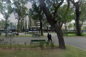 two people walking in a park next to a tree at Apto Clássico, Centro de Friburgo, em frente à Pça Getúlio Vargas e pertinho do Teleférico e da Pça Suspiro - Muito bem equipado - Aquecedor in Nova Friburgo +3 photos