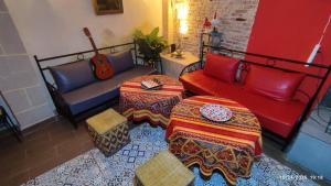 a living room with a couch and a guitar at Riad Bladi Essaouira in Essaouira