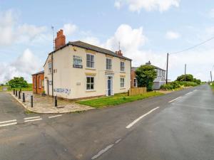 a white building on the side of a street at 2 Bed in Kilnsea 83428 in Kilnsea