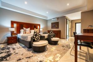 a hotel room with a bed and a piano at Simanya River Lodge in Kanyekama +99 photos