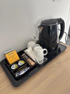 a tray with a coffee pot and other items on it at Lady Hamilton B&B in Feletto