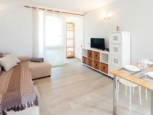 a white living room with a couch and a table at Easystay Costa del Silencio Wifi in Costa Del Silencio +2 photos