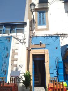 a blue and white building with a door at Riad Bladi Essaouira in Essaouira