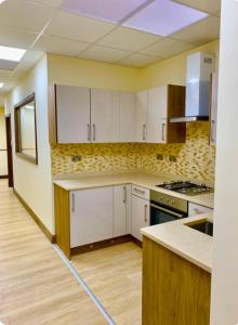 a kitchen with white cabinets and a counter top at Allen's property in Birmingham