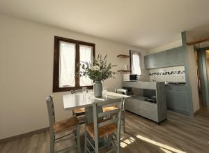 une cuisine avec une table et des chaises et une cuisine avec un comptoir dans l'établissement 8 ARBOUSIERS VILLA 17, à Bonifacio