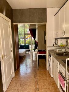 a kitchen with a sink and a washing machine at AlquilerSalou Loft B in Salou