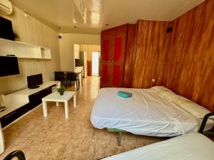 a bedroom with a large bed and a living room at AlquilerSalou Loft B in Salou