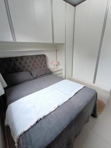 a bedroom with a bed in a white room at Casa Completa em Foz do Iguaçu in Foz do Iguaçu