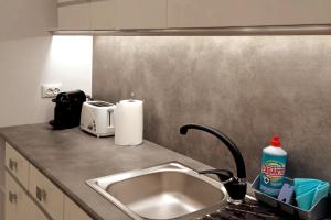 a kitchen counter top with a sink and a sink at Las Américas Seafront - Free Wi-fi in Costa de Adeje +12 photos