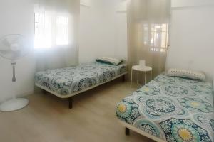 a bedroom with two beds and a window at Las Américas Seafront - Free Wi-fi in Costa de Adeje