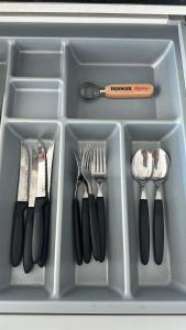 a plastic container with utensils in a drawer at Altamira Surubi-i in Estancia Sarubi +2 photos