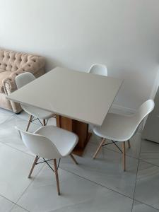 a white table and chairs in a room with a couch at Altamira Surubi-i in Estancia Sarubi