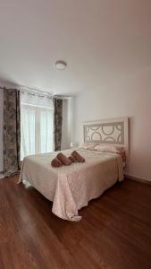 a bedroom with a large bed and a window at VILLA CHRIS Ocean View in La Jaca