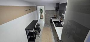 a kitchen with a counter and stools in a room at Einzigartiges Apartment, mitten in der Natur in Ottenhöfen