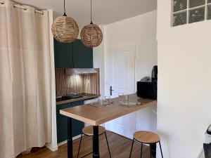 a kitchen with a table with wine glasses on it at Appartement à Manosque - Centre Historique in Manosque