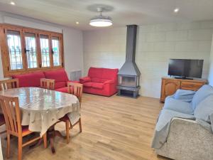 a living room with a table and a fireplace at La Casa de la Huerta de Redován in Redován