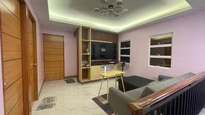 a living room with a couch and a television at Silang Guest house in Bangkal